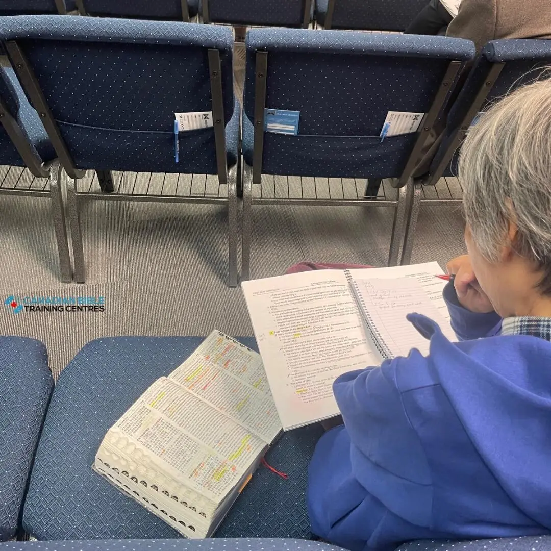 Student praying during a Calgary Bible study at Canadian Bible Training Centres