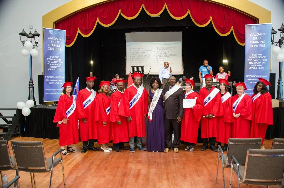 Graduates in red gowns on stage at Canadian Bible Training Centres